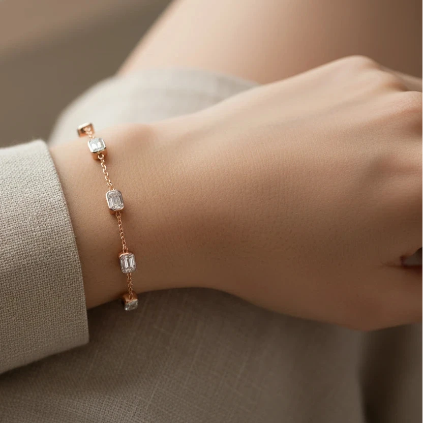 Rose gold bracelet with diamond accents on a white background